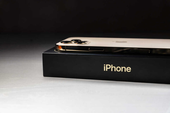 Close-up of an iPhone resting on its box