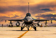F-16 fighter jet on an airbase during sunset