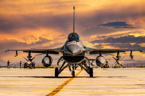 F-16 fighter jet on an airbase during sunset