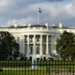 The White House with an American flag flying above it