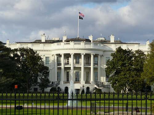 The White House with an American flag flying above it