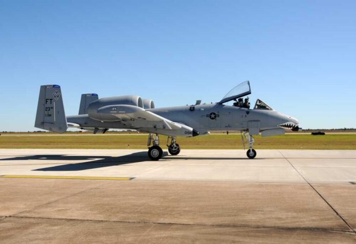 A military A-10 Thunderbolt aircraft on a runway