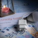 Electricity bill with euros, a light bulb, and a candle