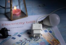 Electricity bill with euros, a light bulb, and a candle