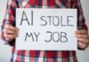 Person holding a sign that reads 'AI stole my job'