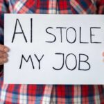 Person holding a sign that reads 'AI stole my job'