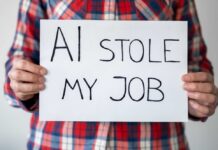 AI Job Apocalypse: Six-Figure Engineer Now a Dasher Person holding a sign that reads 'AI stole my job'