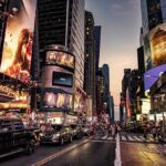 Busy street scene in Times Square with cars and pedestrians
