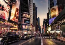 Busy street scene in Times Square with cars and pedestrians