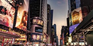 Busy street scene in Times Square with cars and pedestrians