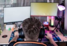 Rich Socialist Sparks Heated Debate Over Hypocrisy Person wearing headphones at a gaming setup with dual monitors