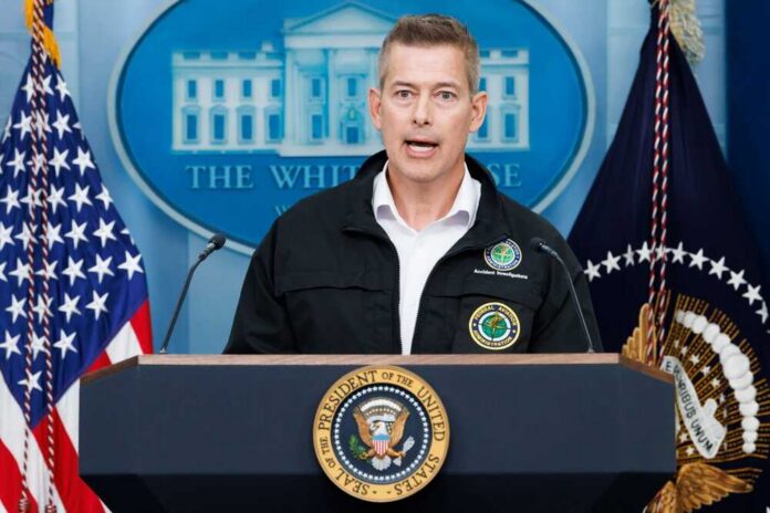 Government official speaking at a press conference in front of the White House