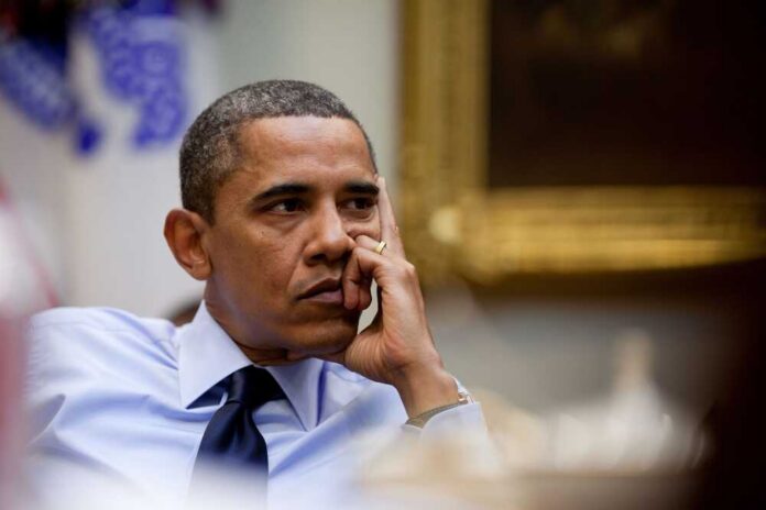 A thoughtful man resting his chin on his hand during a meeting