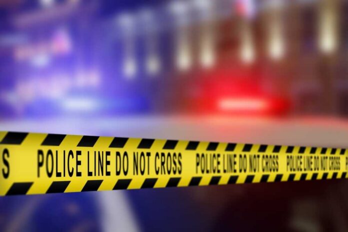 shutterstock_2621496989.jpg Yellow police caution tape with the text 'POLICE LINE DO NOT CROSS' in a blurred background