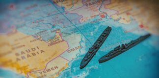A close-up of a map featuring military ships in the Arabian Sea