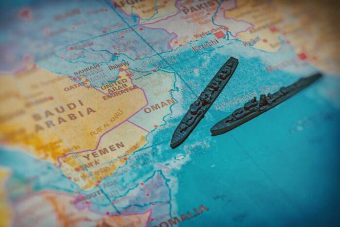 A close-up of a map featuring military ships in the Arabian Sea