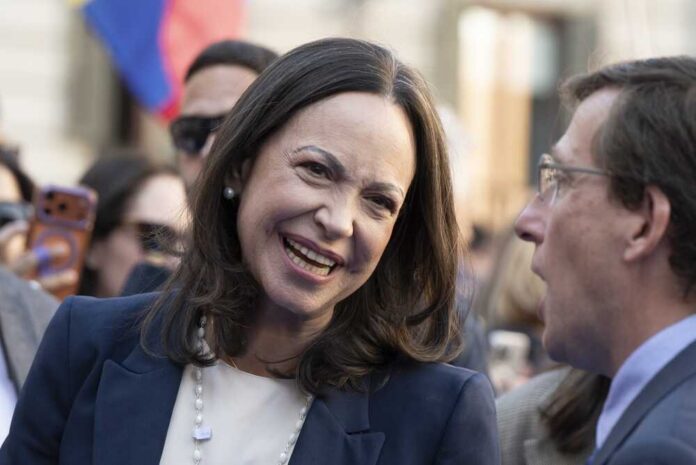 A woman smiling while engaging in conversation at a public event