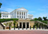 Historic government building with white columns and green lawn