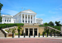 Historic government building with white columns and green lawn