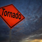Infrastructure CRUMBLES: Midwest Tornado Outbreak Tornado warning sign against a dramatic sky