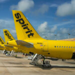 Yellow Spirit Airlines planes parked at the airport.