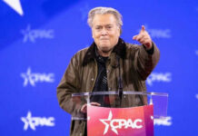 Person speaking at CPAC conference blue background