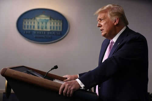 Man speaking at a podium in a room