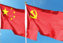 Chinese flag and Soviet flag against blue sky.