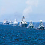 UK’s Bold Naval Gambit Shakes Arctic Balance A fleet of warships sailing in formation on the ocean