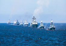 A fleet of warships sailing in formation on the ocean