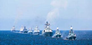 A fleet of warships sailing in formation on the ocean