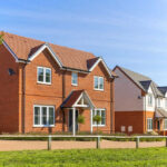 Housing Dream Dead: 49% Can’t Afford Entry Level Red-brick suburban house in a sunny neighborhood.