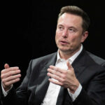 Man in suit gesturing during a conversation