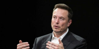 Man in suit gesturing during a conversation
