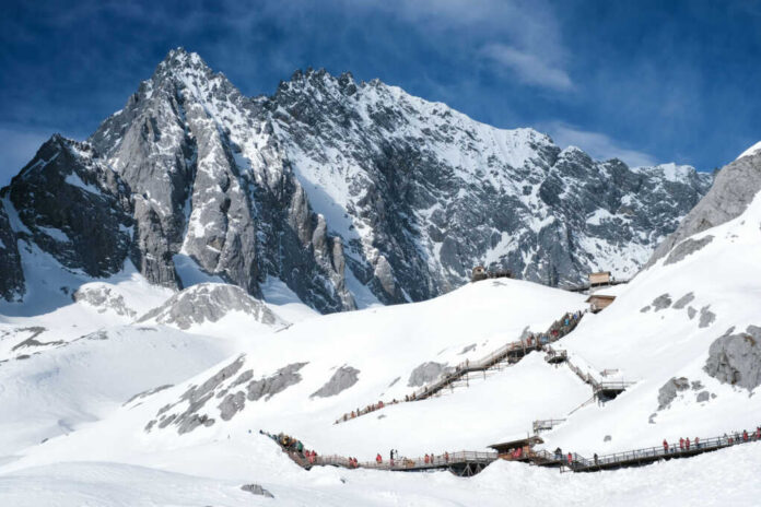 jade-dragon-snow-mountain2444791363jpg Snowy mountain landscape with wooden walking paths tourists