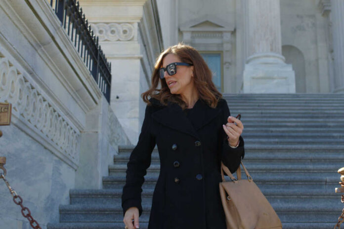 nancy-mace2431928559jpg Woman in black coat on stone steps outside a classical building