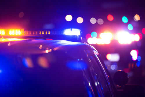 Police car lights flashing in the dark night