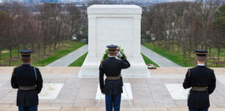 Military personnel saluting at the Tomb of the Unknown Soldier