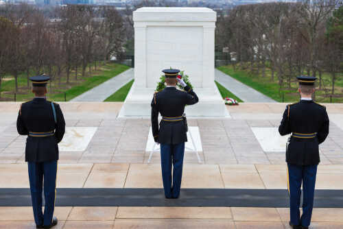 Military personnel saluting at the Tomb of the Unknown Soldier