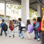 Pediatric Dementia Crisis: Scammers Prey on Families Group of children walking towards a school bus