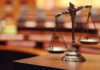 Close-up of a decorative scales of justice in a courtroom setting