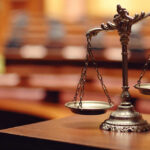 Deadly Custody Battle: Mom Hires Hitman Close-up of a decorative scales of justice in a courtroom setting