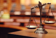Close-up of a decorative scales of justice in a courtroom setting