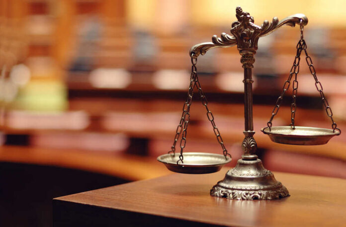 Close-up of a decorative scales of justice in a courtroom setting