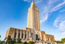 Louisiana State Capitol building towering against a blue sky