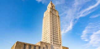 Louisiana State Capitol building towering against a blue sky