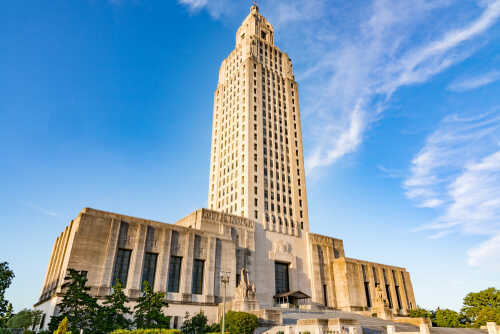 Louisiana State Capitol building towering against a blue sky