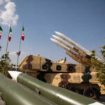 Classified Reports Expose China-Iran Weapon Ties Military missiles displayed outdoors with Iranian flags in the background