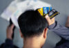 Person holding multiple credit cards while looking stressed