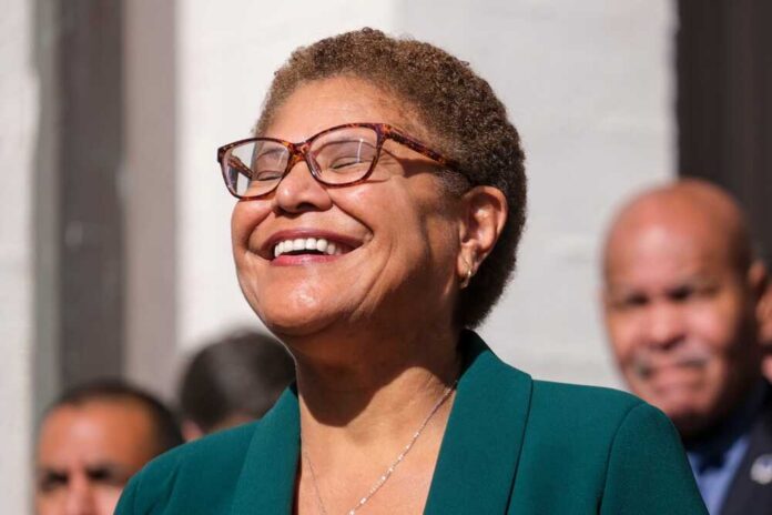 A woman with glasses smiling joyfully at an outdoor event